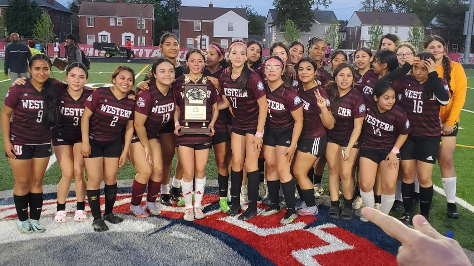  Girls Varsity Soccer holding their 9th straigh PSLt championship trophy.